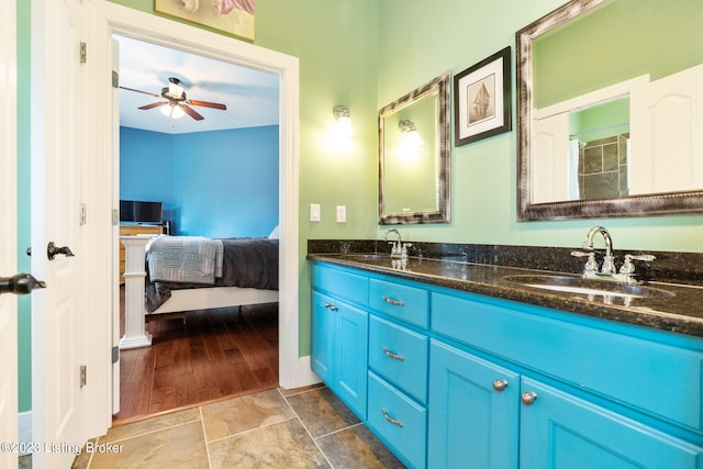 bathroom featuring dual bowl vanity, ceiling fan, and tile floors