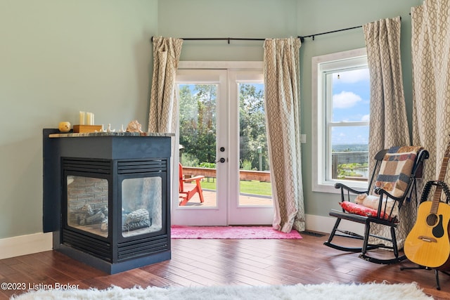 doorway featuring dark hardwood / wood-style flooring, french doors, and a multi sided fireplace