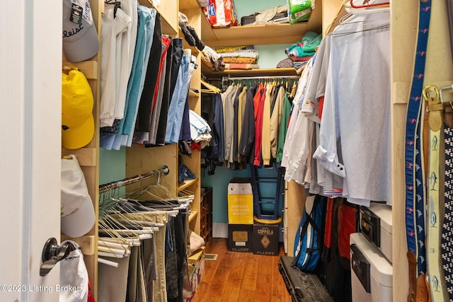 spacious closet with dark hardwood / wood-style flooring