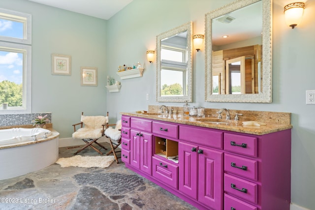 bathroom featuring double sink, tile floors, oversized vanity, and a bath to relax in