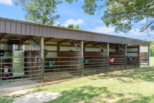 view of horse barn with a lawn and an outdoor structure