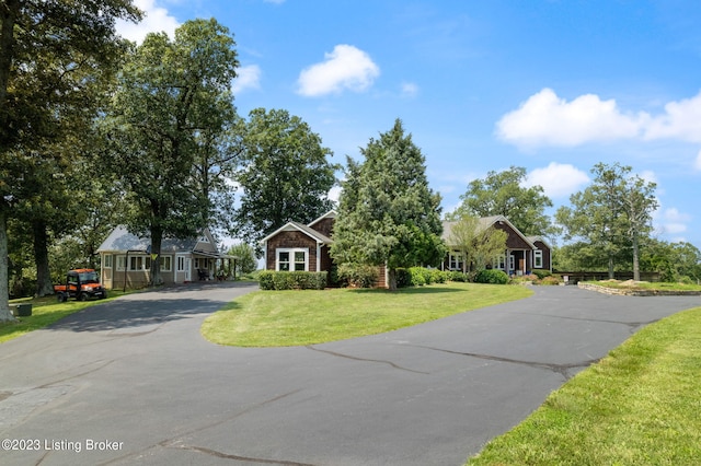 ranch-style home featuring a front yard