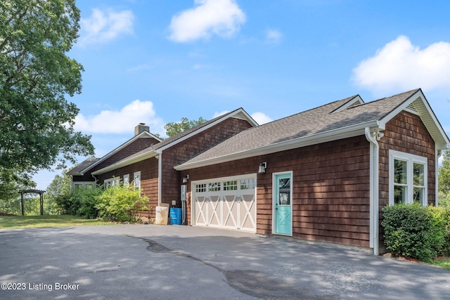 view of side of property with a garage