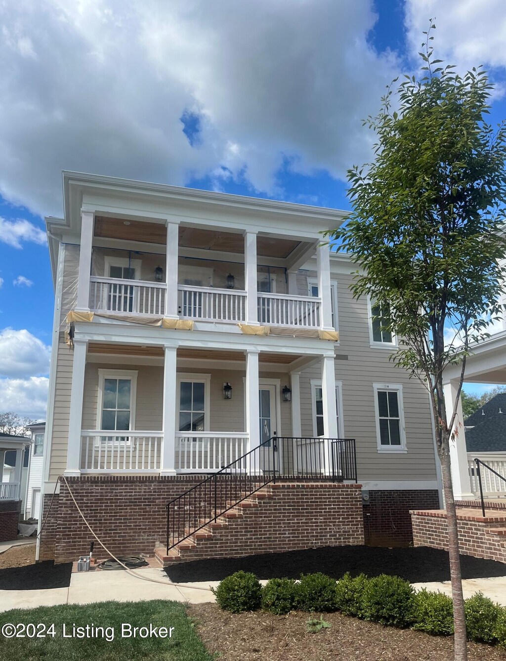 neoclassical / greek revival house featuring a balcony