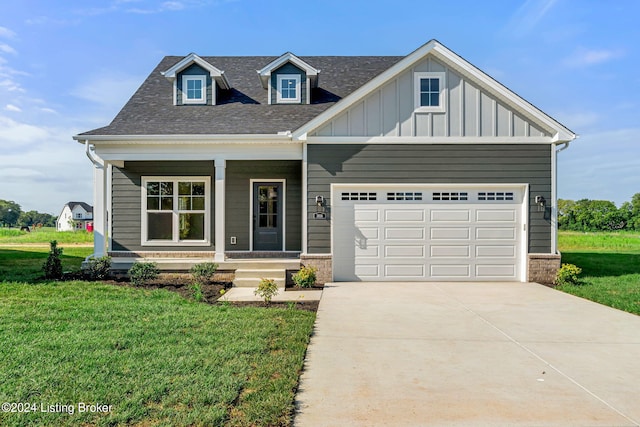 craftsman-style house with driveway, an attached garage, a front lawn, a porch, and board and batten siding