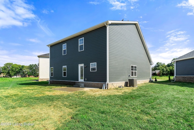 rear view of house featuring entry steps, central AC unit, and a lawn