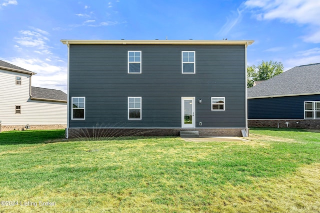 rear view of house with a lawn