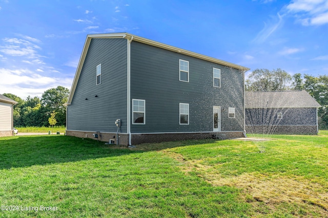 rear view of house with a yard