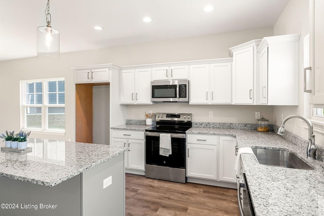 kitchen featuring stainless steel appliances, a sink, and white cabinets