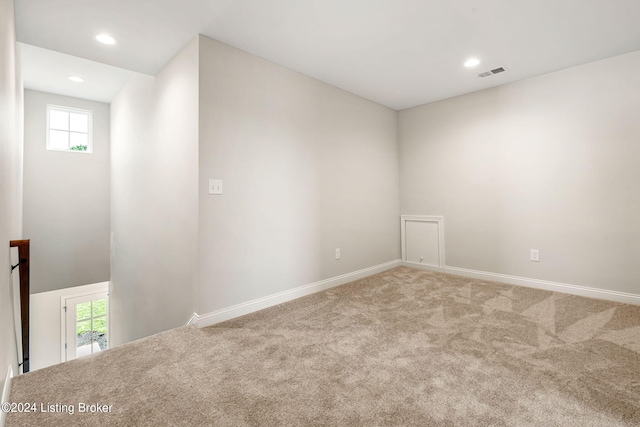 empty room with recessed lighting, carpet, visible vents, and baseboards