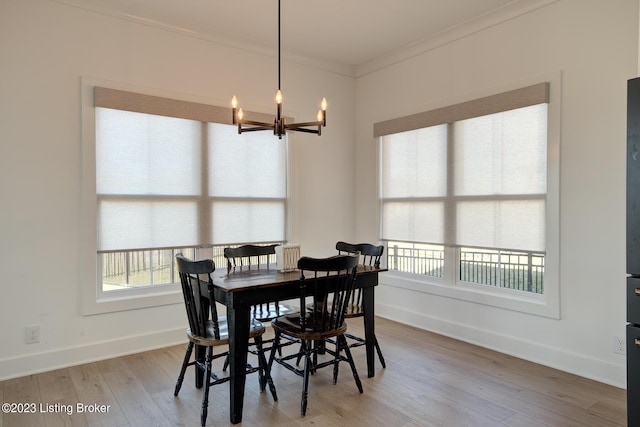 dining space featuring a notable chandelier, crown molding, a wealth of natural light, and wood-type flooring