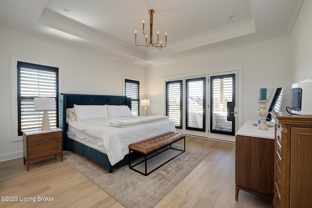 bedroom with a raised ceiling and multiple windows