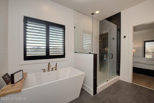 bathroom featuring plus walk in shower and tile patterned floors