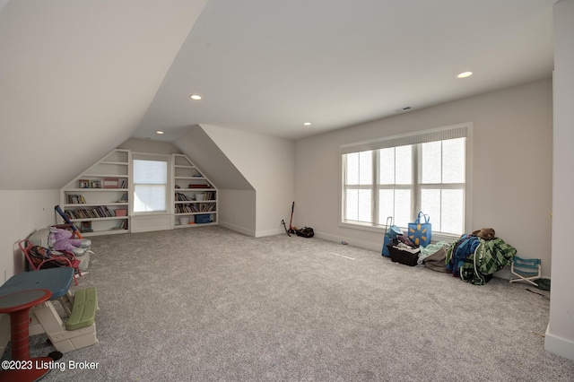 playroom featuring carpet, lofted ceiling, and built in shelves