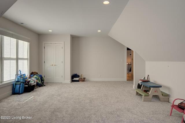 game room featuring light carpet, vaulted ceiling, and a healthy amount of sunlight