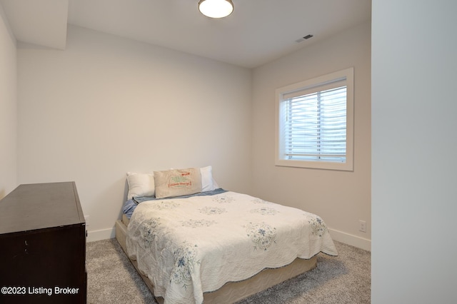 bedroom featuring light carpet