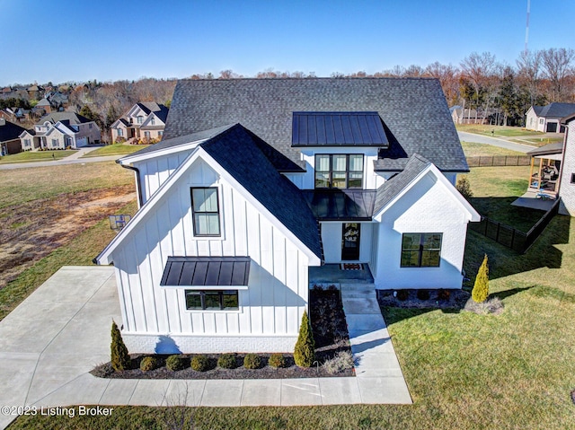 modern farmhouse with a balcony and a front lawn