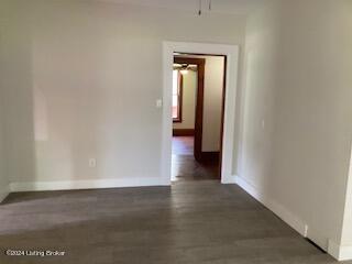 spare room with dark hardwood / wood-style floors and ceiling fan