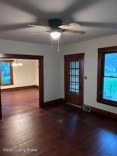 entrance foyer featuring ceiling fan, plenty of natural light, and dark wood-type flooring