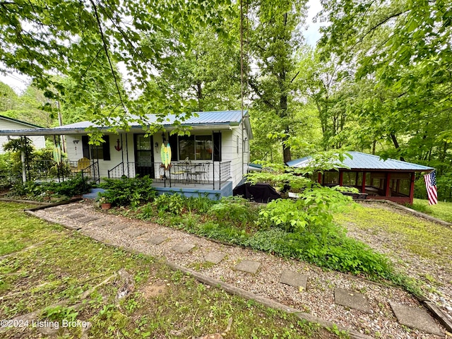 view of front of property with metal roof and a porch