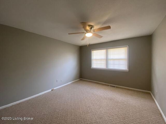 empty room with light colored carpet and ceiling fan