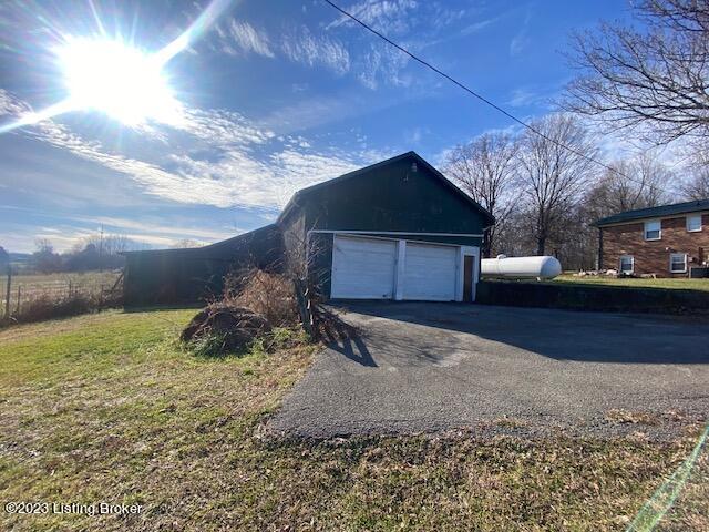 garage featuring a lawn