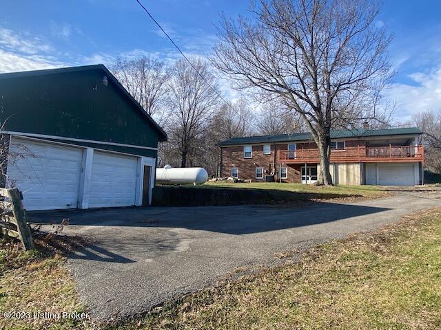 view of side of home featuring a garage and an outbuilding