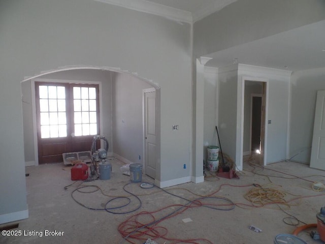 unfurnished living room with french doors and crown molding