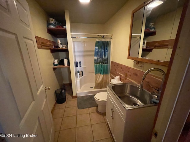 bathroom with a shower, tile patterned floors, vanity, and toilet