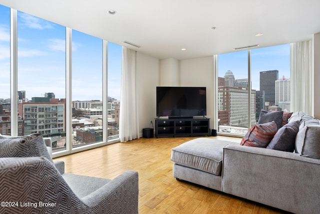 living room featuring floor to ceiling windows and light hardwood / wood-style floors