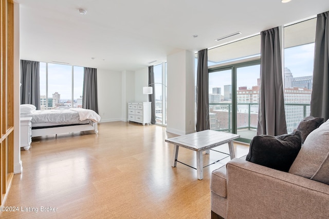 bedroom with floor to ceiling windows and access to exterior