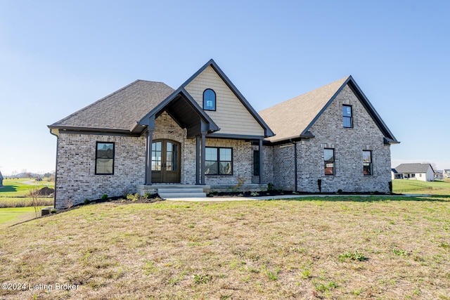 view of front of house with french doors and a front lawn