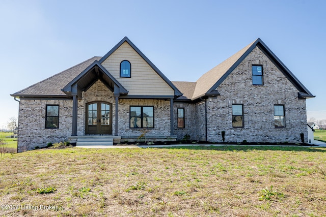 view of front of house featuring a front lawn and french doors