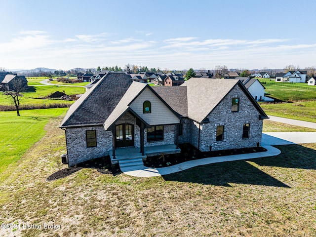 french provincial home featuring a porch and a front lawn