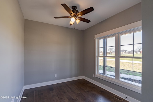 empty room featuring dark hardwood / wood-style floors and ceiling fan