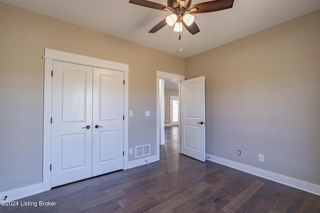 unfurnished bedroom featuring ceiling fan, a closet, and dark hardwood / wood-style floors