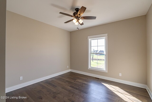 unfurnished room with ceiling fan and dark wood-type flooring