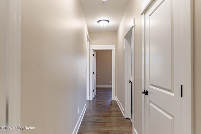 corridor with dark hardwood / wood-style flooring