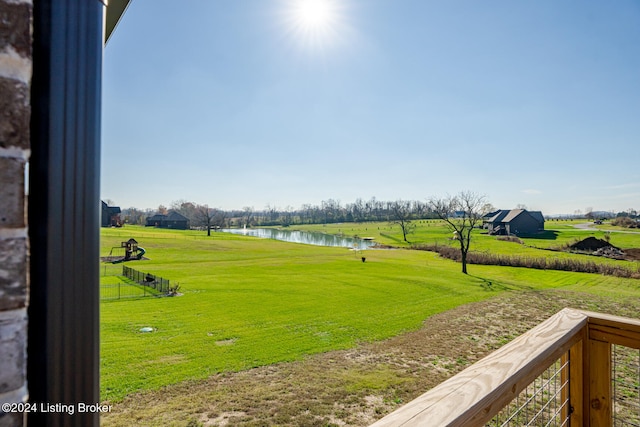 view of community featuring a lawn and a water view