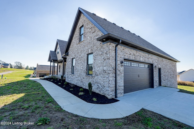 view of home's exterior with a yard and a garage