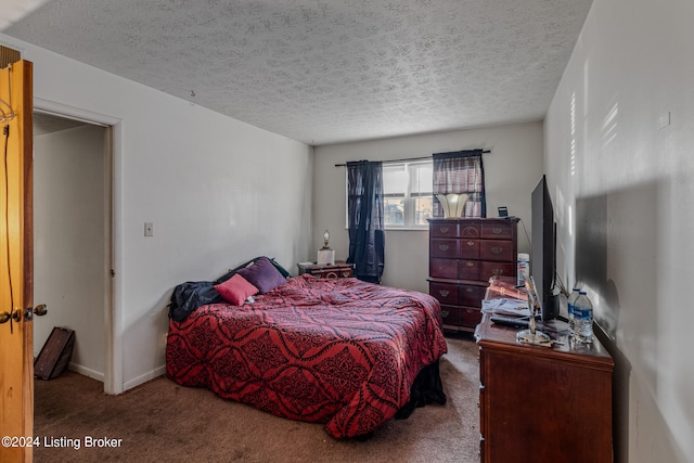 bedroom with carpet and a textured ceiling