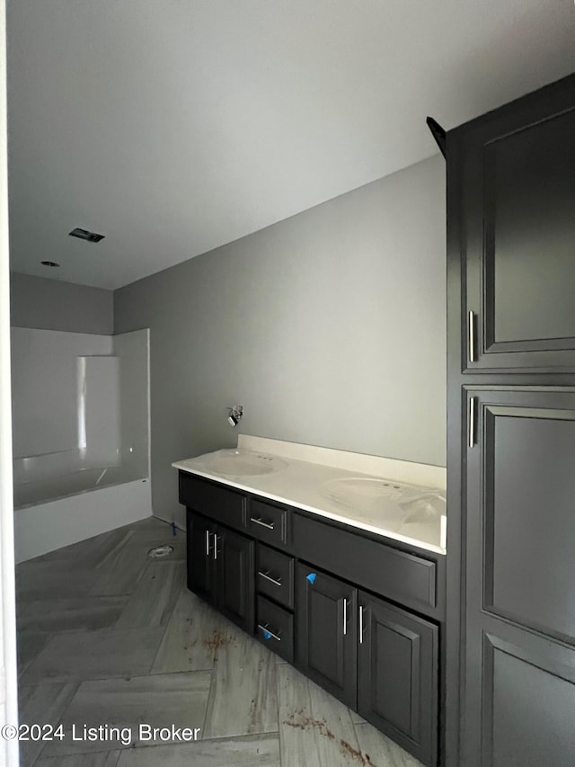 bathroom with double vanity and tile patterned floors