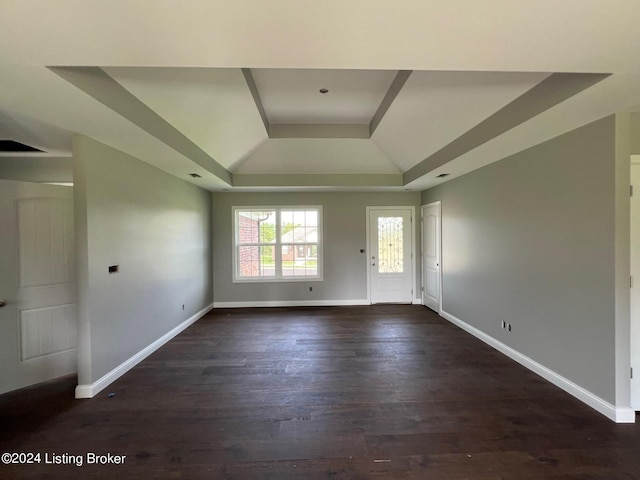 interior space featuring dark hardwood / wood-style floors and a tray ceiling