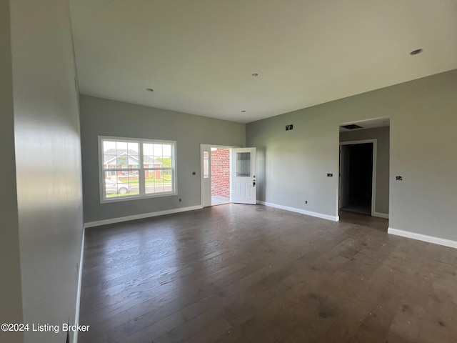 unfurnished living room with dark hardwood / wood-style flooring