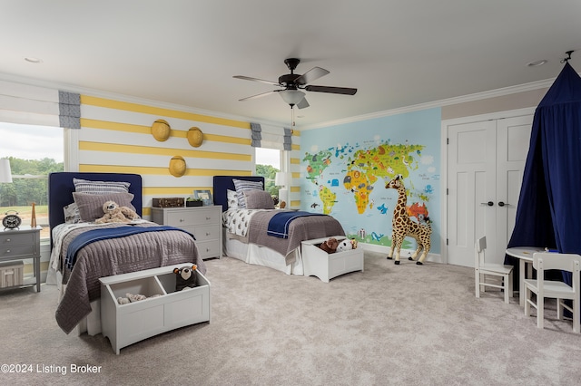 carpeted bedroom featuring a closet, ceiling fan, and crown molding