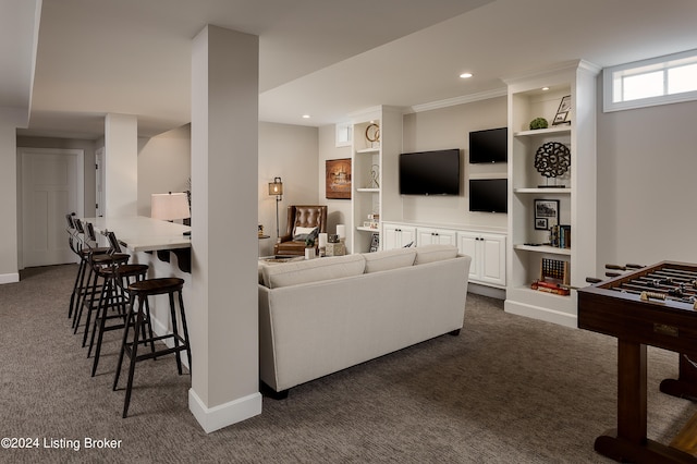 carpeted living room with built in shelves and crown molding