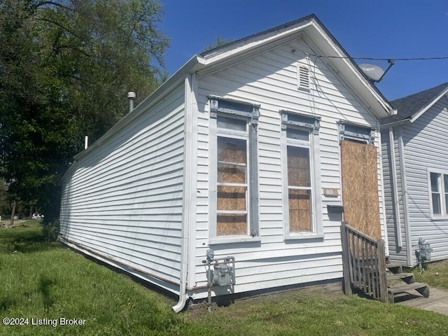 view of side of property with a yard