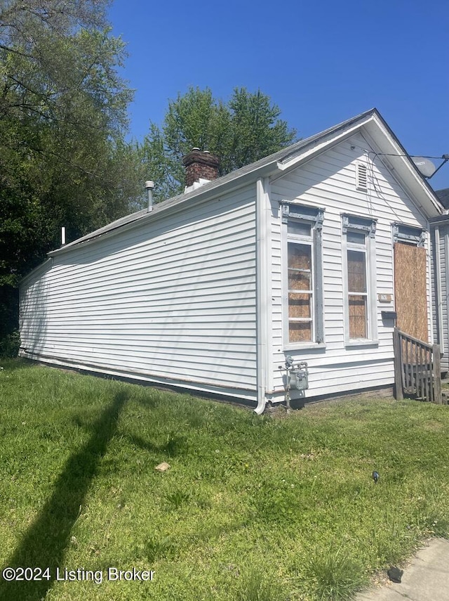 view of property exterior with a yard