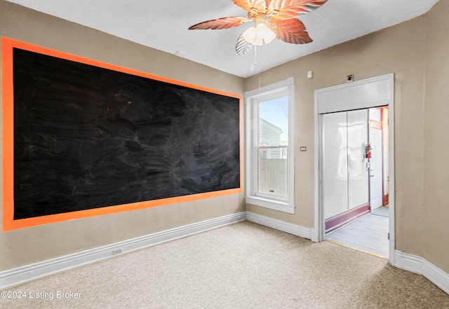 carpeted empty room with ceiling fan