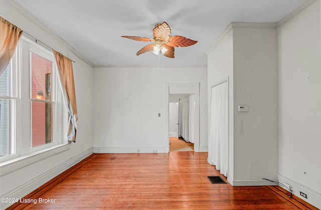 unfurnished room with ceiling fan, ornamental molding, and light wood-type flooring